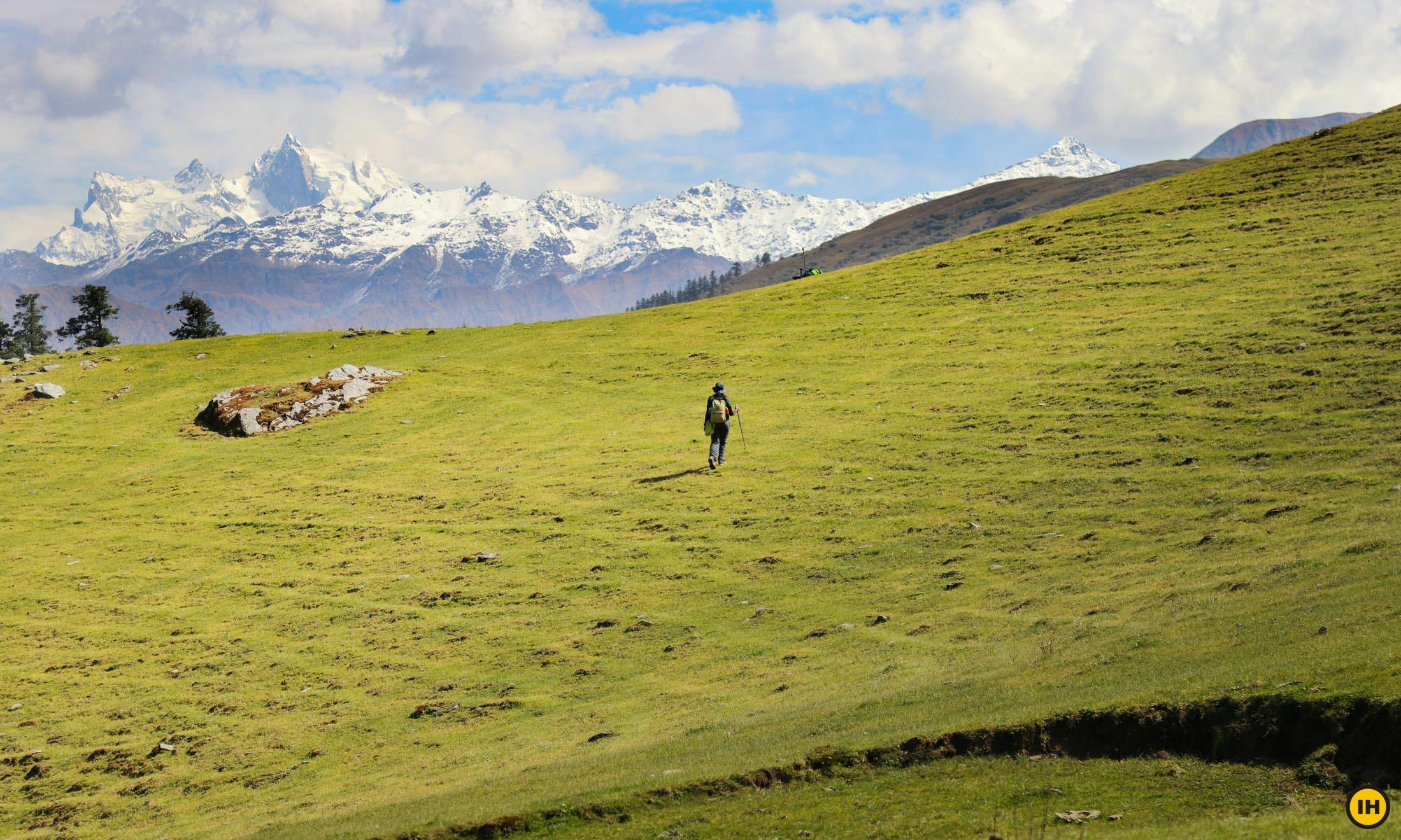 A trekker enjoying some alone time on the meadows of Phulara ridge trek 