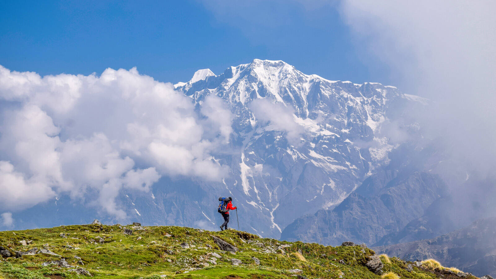 low-preview-A trekker walks against the backdrop of big mountains of Kumaon on the way to ranthan kharak